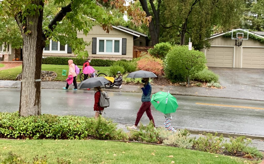 Umbrellas come out to start the school day in Menlo Park