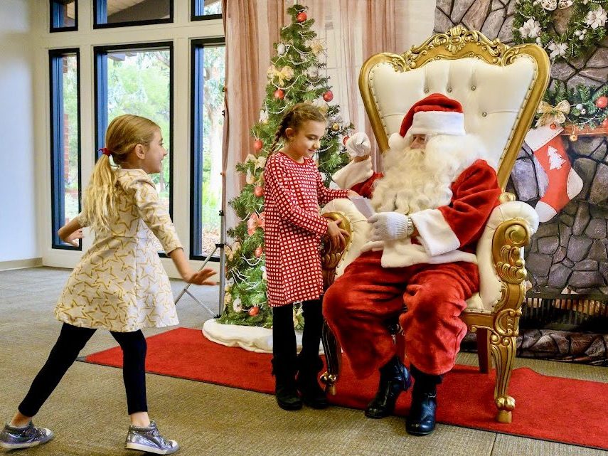 Kids visit with Santa and enjoy crafts this morning in Menlo Park