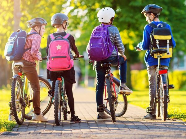 kid cycling with backpacks
