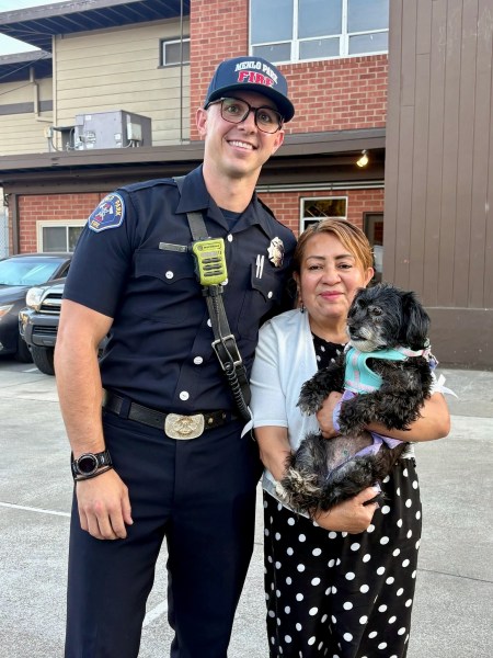 Firefighter Tyler with Prieta and owner